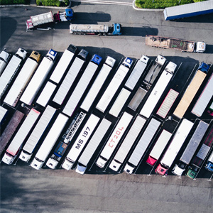 view looking down on parking lot full of semi trucks